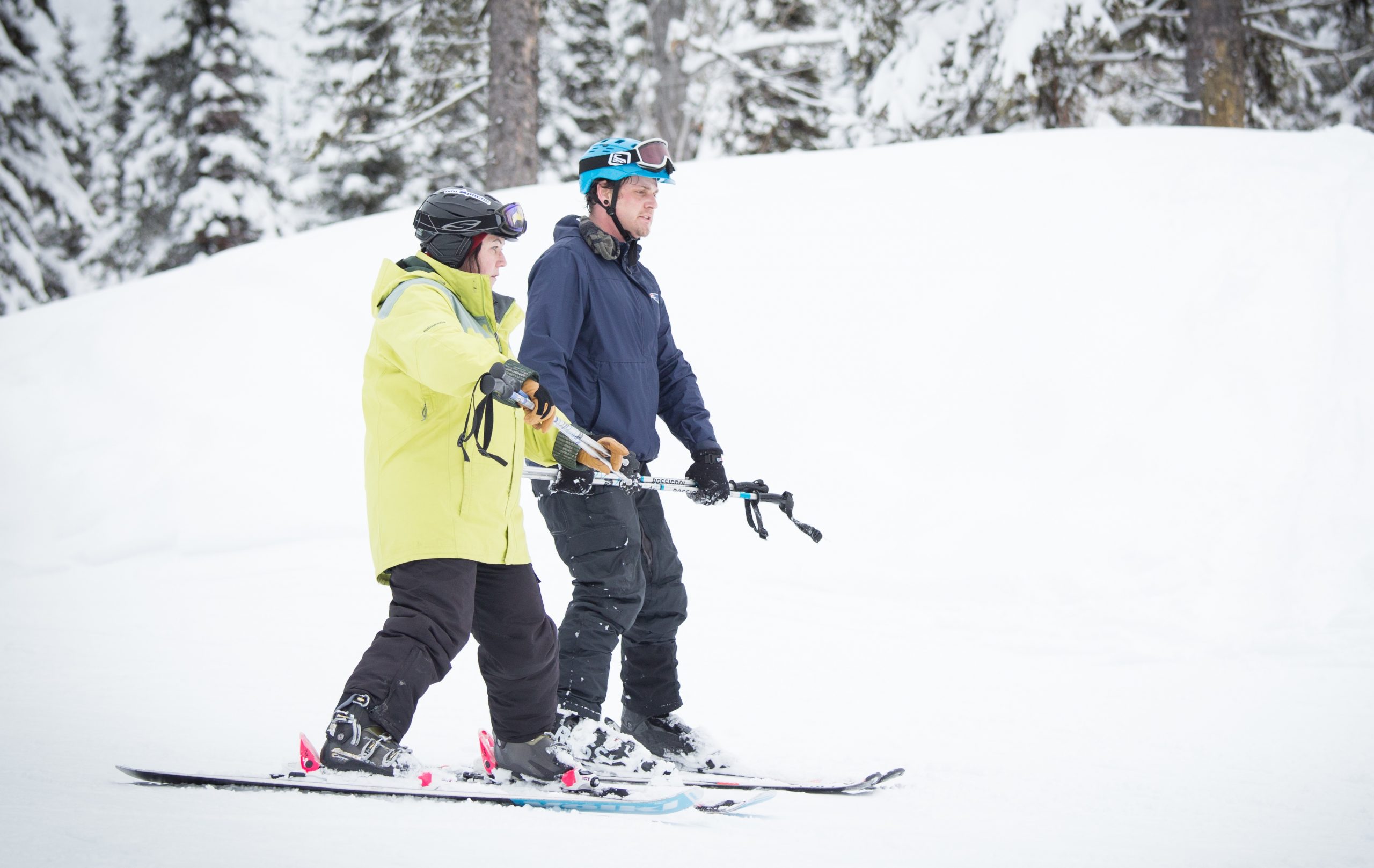 A Dream volunteer skiing with a participant