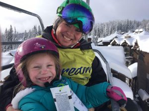 Photo of a female Dream volunteer with a participant on a chairlift.