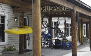 Storefront of Runner Up Sports with bikes hanging from awning roof.