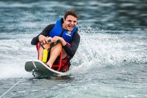 Sit Ski Waterskier being pulled behind a boat